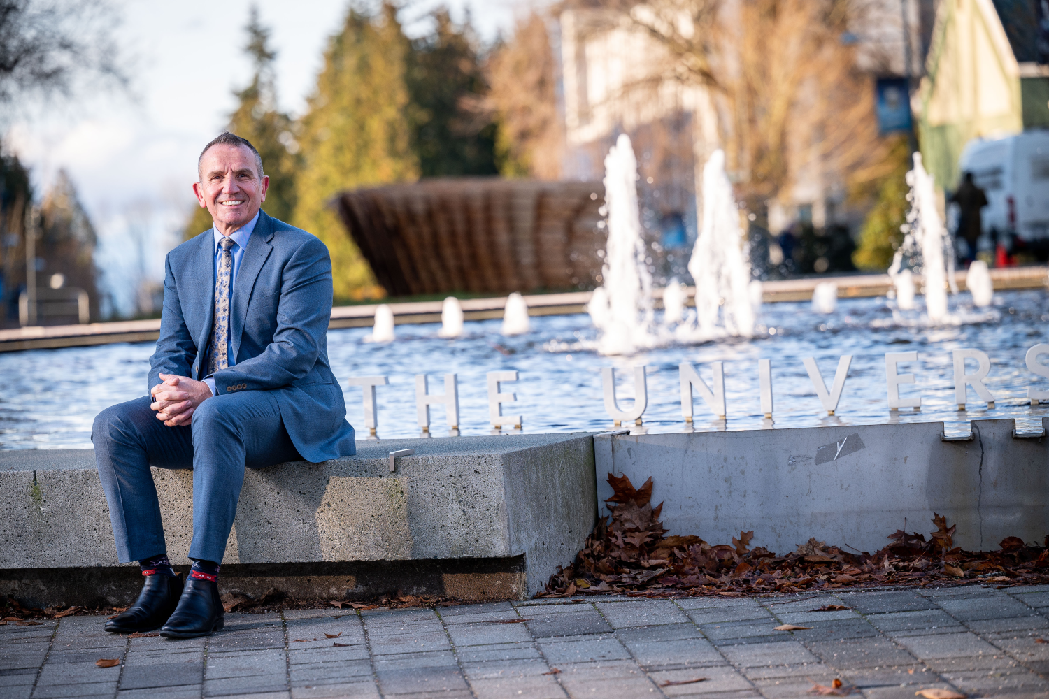 Frank Laezza sits by the fountain at Martha Piper Plaza on UBC's Vancouver campus. 